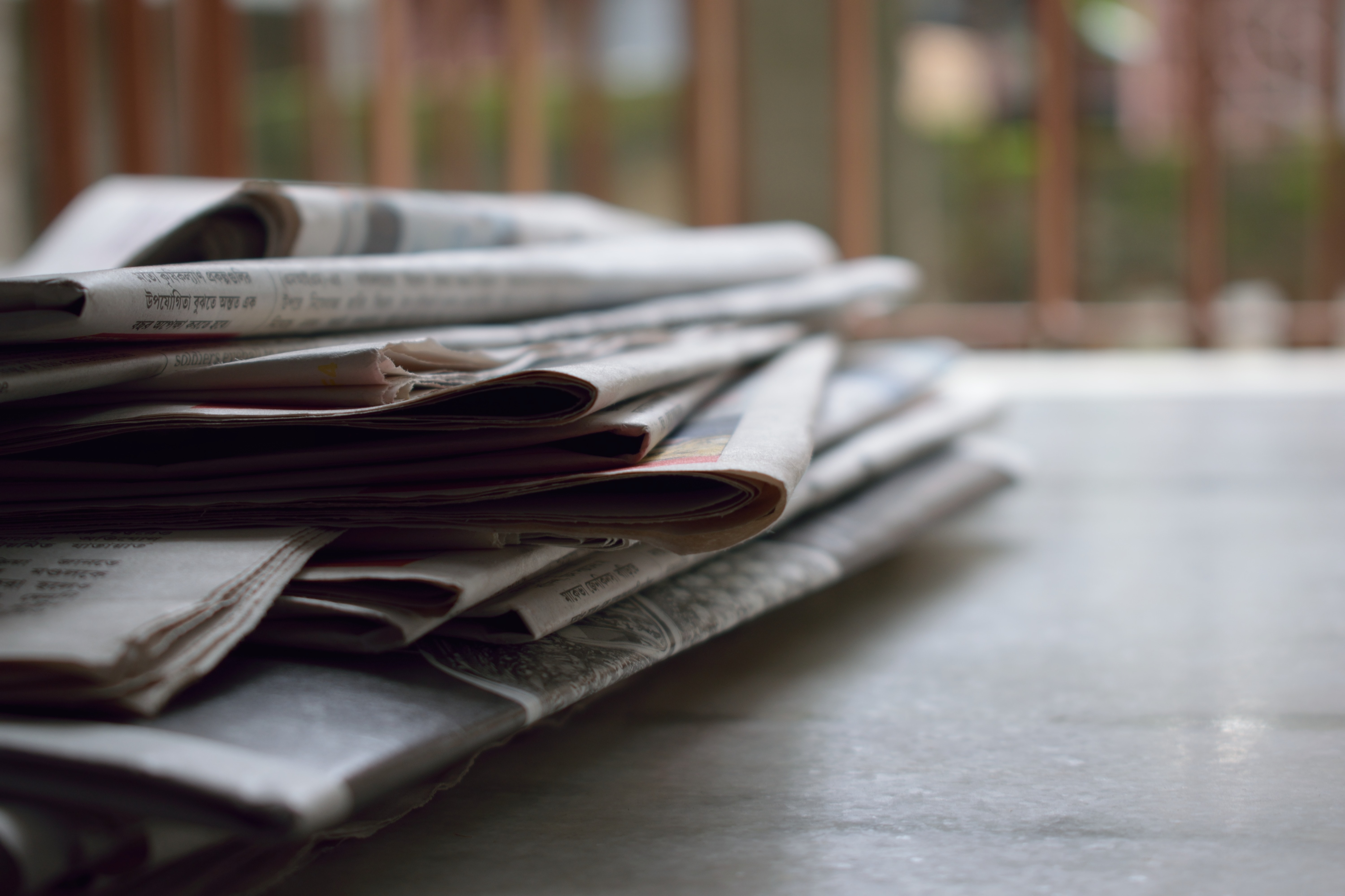 Newspapers placed on a table.